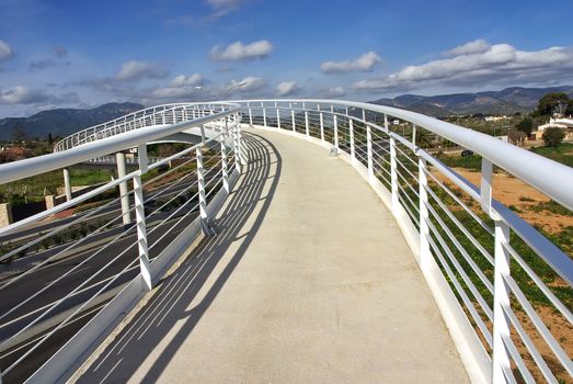 White pedestrian bridge over a highway in Majorca (Spain)
