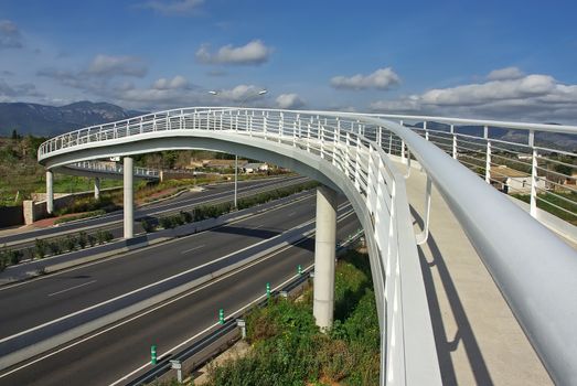 White pedestrian bridge over a highway in Majorca (Spain)