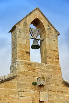 Bell tower over an ancient spanish church