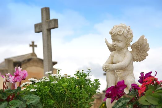 Statue of an angel boy located in a cemetery