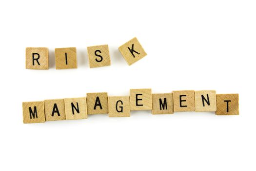 RISK MANAGEMENT word wooden alphabet blocks on white background from top view