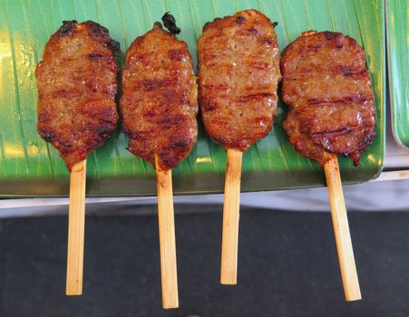 closed up the stick of thai roasted pork