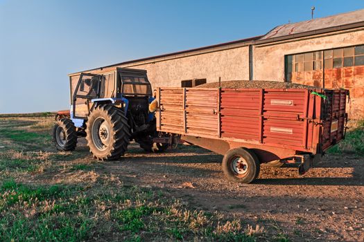 farm tractor with towing full of grain