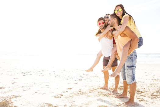 Group of friends having fun at the beach