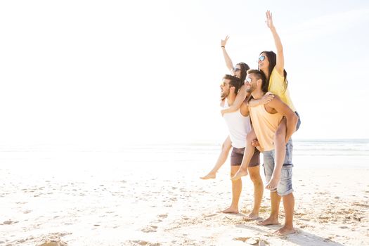 Group of friends having fun at the beach