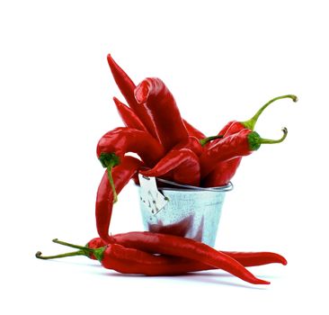 Heap of Perfect Red Hot Chili Peppers in Tin Bucket isolated on White background