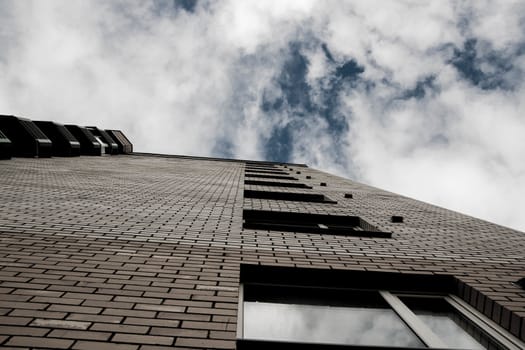 view of the building from the bottom up plus views of the blue cloudy sky