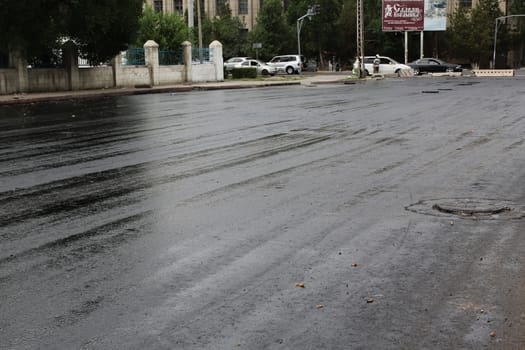 Freshly laid black tar asphalt pavement - a new road surface made of bitumen.