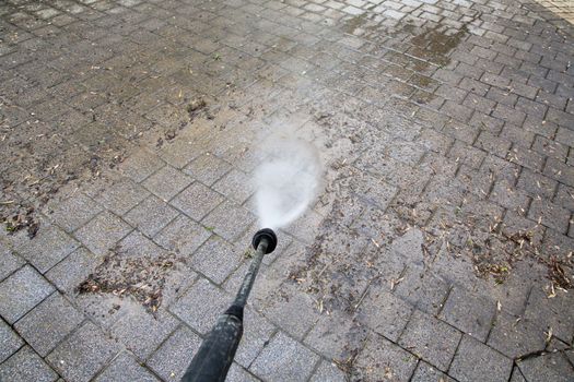 Outdoor floor cleaning with high pressure water jet