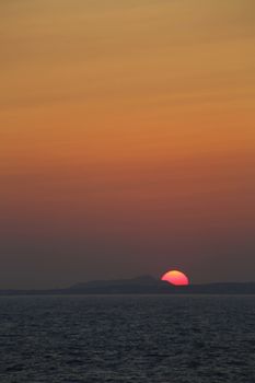 Sunset at the Portara Gate of the Apollo Temple in Naxos island