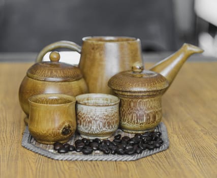 Soft focus image of coffee beans and coffee cups set on wooden background.Vintage style.(soft focus)