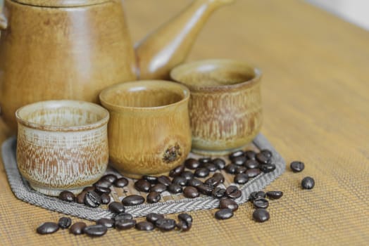 Soft focus image of coffee beans and coffee cups set on wooden background.Vintage style.(soft focus)