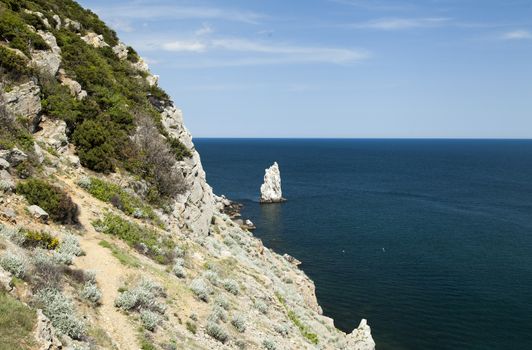 Mountains by the sea in beams of a bright sun