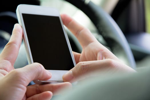 Woman Sitting in the Car and Using Smart Phone
