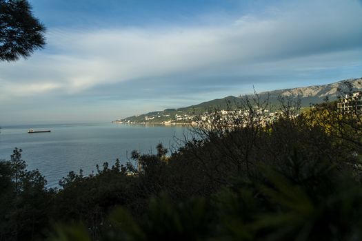 Mountains by the sea in beams of a bright sun