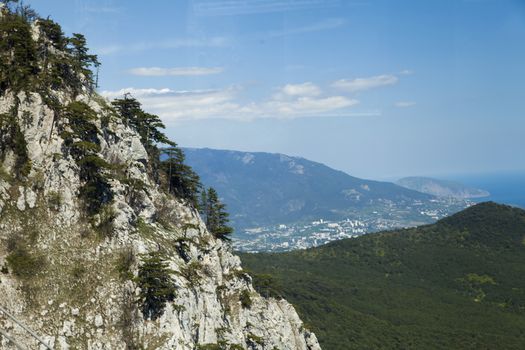 Mountains by the sea in beams of a bright sun