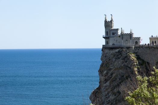 The castle by the sea is on the rock highly above water