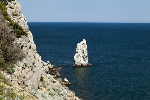 Mountains by the sea in beams of a bright sun