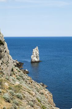 Mountains by the sea in beams of a bright sun