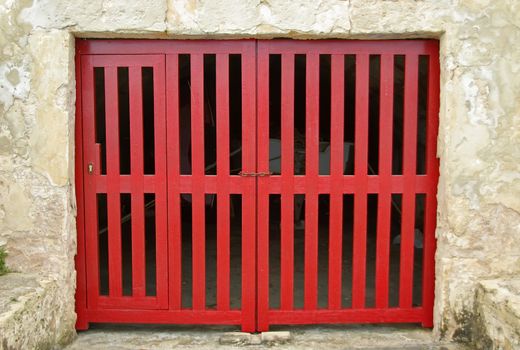 Old Red Wooden Door of a boat shelter in the Mediterranean Sea (Majorca)