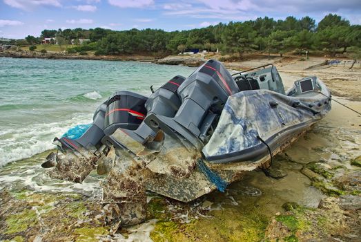 shipwreck of an small boat often used for illegal immigration from Africa in the coast of Majorca in Spain