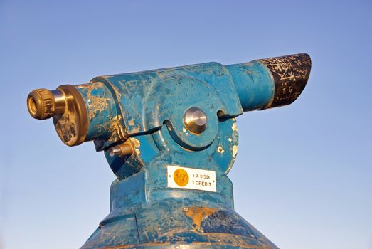 Blue and old coin operated telescope in Spain