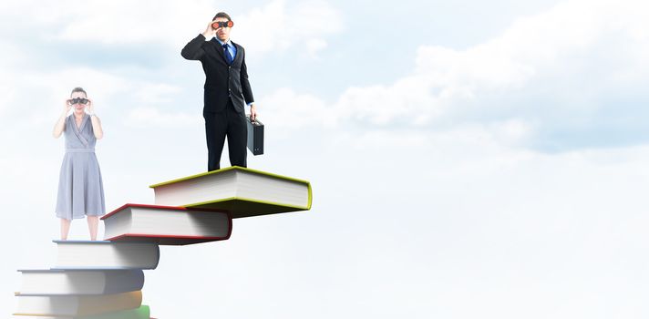 A businesswoman looking through binoculars against blue sky