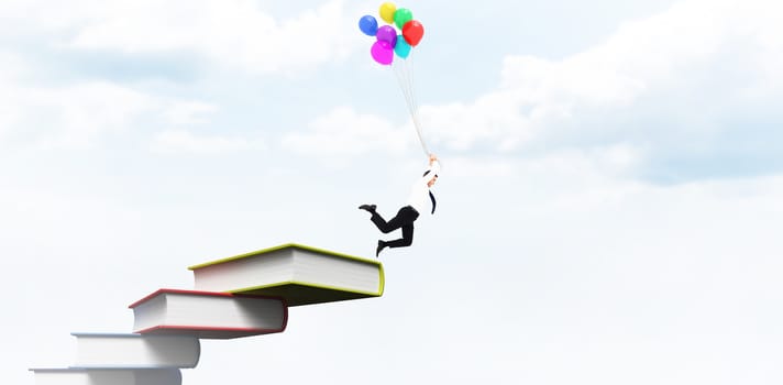 Businessman flying with balloons against blue sky