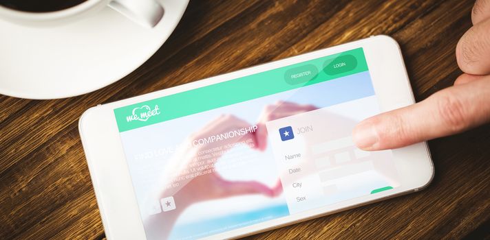 Dating website against smartphone on desk