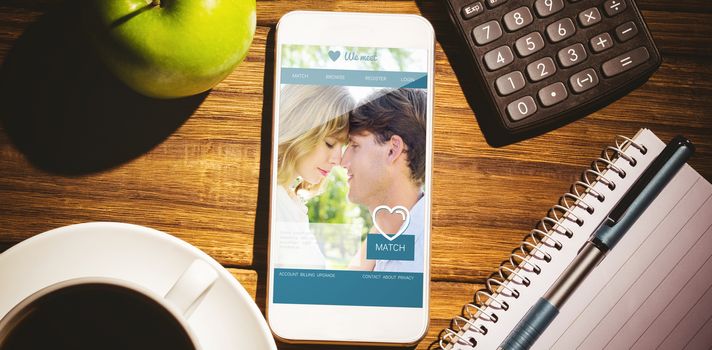 Dating website against smartphone on desk