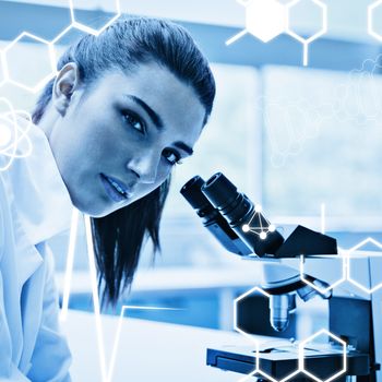 Science graphic against brunette posing with a microscope