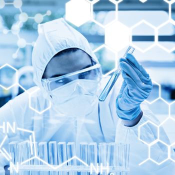 Science graphic against protected scientist looking at a test tube