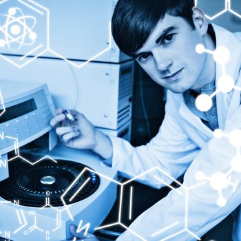 Science graphic against chemist using a centrifuge