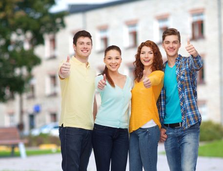 friendship, education, summer vacation and people concept - group of smiling teenagers showing thumbs up over campus background