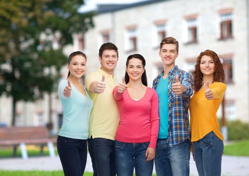 friendship, education, summer vacation and people concept - group of smiling teenagers showing thumbs up over campus background