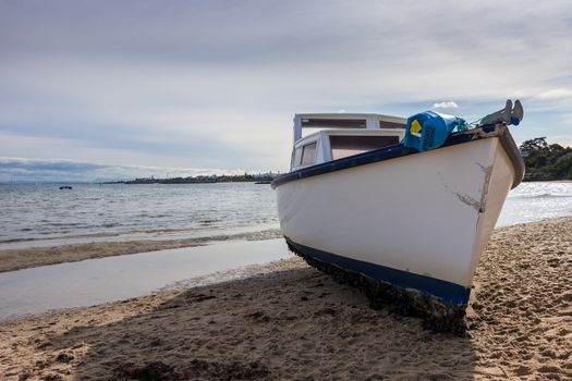 a fishing boat washed up on a beach from a  recent storm in Melbourne.