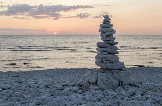 Rocks Piled on Each Other by ocean at sunset.