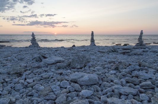 Rocks Piled on Each Other by ocean at sunset.