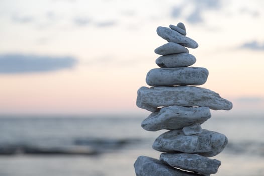 Rocks Piled on Each Other by ocean at sunset.