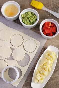 Ingredients for baking bun of puff pastry with cheese, tomato, avocado