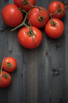 Fresh tomatoes on vintage wooden table