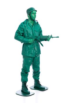 Man on a green toy soldier costume with riffle isolated on white background.