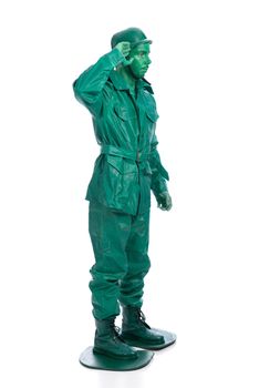 Man on a green toy soldier costume saluting isolated on white background.