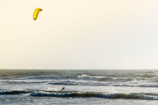 Kitesurfer on a beautiful background of spray during the sunset.
