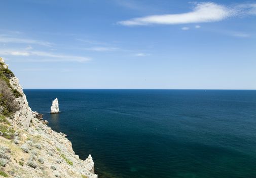 Mountains by the sea in beams of a bright sun