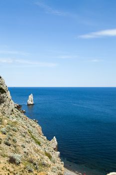 Mountains by the sea in beams of a bright sun