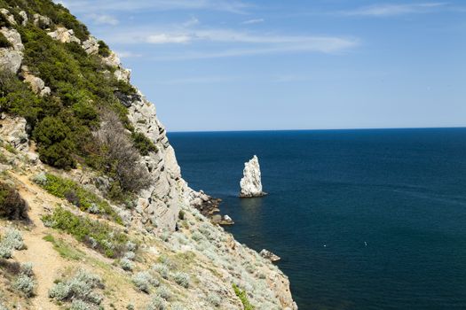 Mountains by the sea in beams of a bright sun