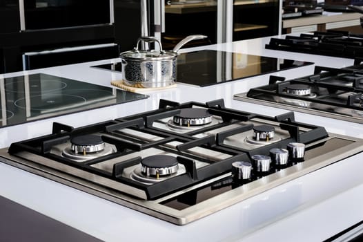 Brand new never used gas stove with stainless tray in appliance retail store
