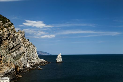 Mountains by the sea in beams of a bright sun