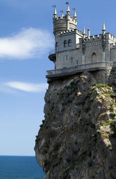 The castle by the sea is on the rock highly above water